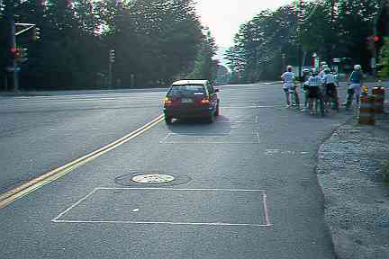 Bicyclists waiting for traffic light that would not trip (12 kB JPEG)